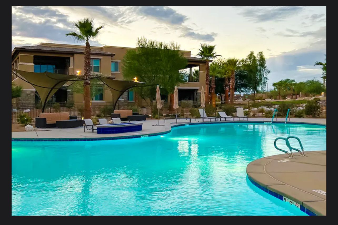 Retreat at The Willow - Palm Desert, CA Luxury swimming pool area at The Willow Palm Desert retreat with lounge chairs, umbrellas, and modern amenities.