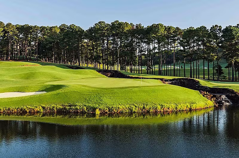 Scenic golf course with lush green fairways, water hazards, and tall trees, part of RTJ Private Vacation Home Retreat, 4 nights, 3 rounds.