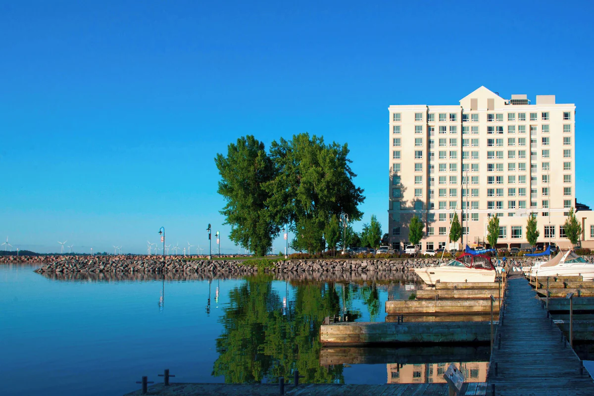 Residence Inn by Marriott Kingston Water's Edge Waterfront view of Residence Inn by Marriott Kingston, featuring a marina with boats and a clear blue sky.