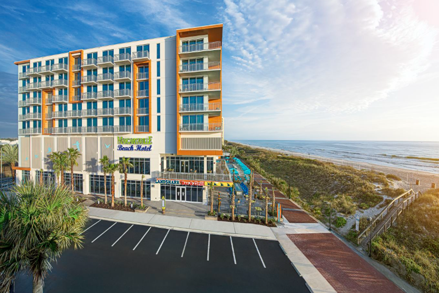 Modern Margaritaville Jacksonville Beach hotel with ocean views, palm trees, and a beachside water park, perfect for a relaxing golf vacation.