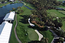 Aerial view of TPC Sawgrass golf course with lush green fairways, sand traps, water hazards, and surrounding trees.