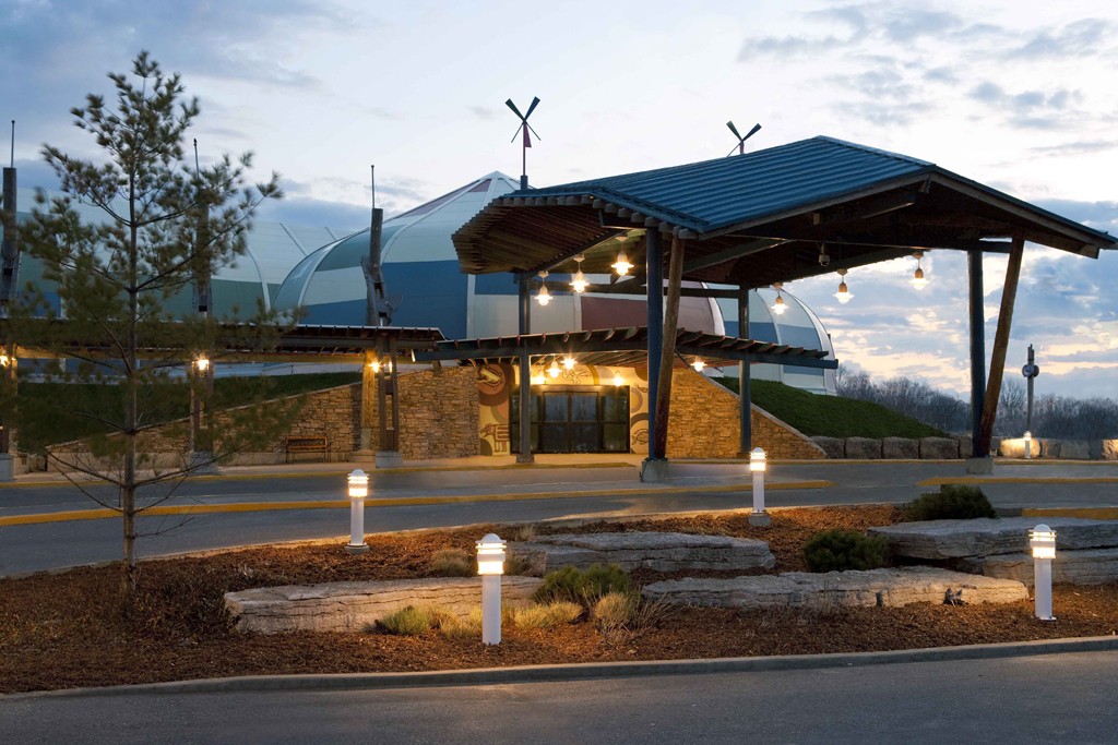 Great Blue Heron Casino Entrance to Great Blue Heron Casino in Ontario, featuring modern architecture, lit path, and a scenic sky backdrop.