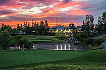 Sunset over Black Gold Golf Club in Yorba Linda, with lush green golf course, water features, and a luxurious clubhouse.