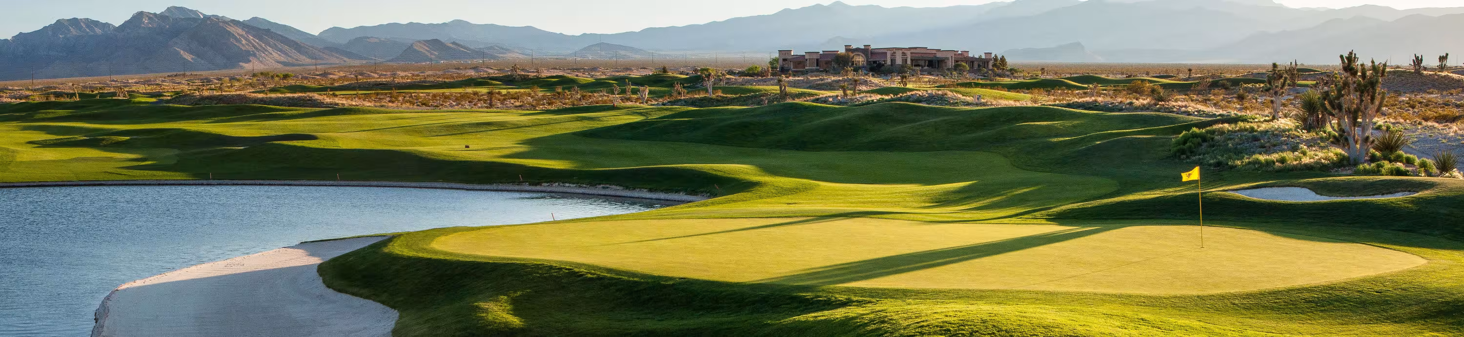 Scenic golf course in Las Vegas with green fairways, water hazards, and mountain views, perfect for golf vacations and packages.