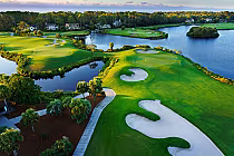 Aerial view of Palmetto Dunes Championship golf course with lush green fairways, sand traps, water hazards, and ocean views.