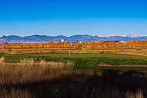 Scenic view of Commonground Golf Course in fall with mountains and blue sky in the background, featuring lush fairways.
