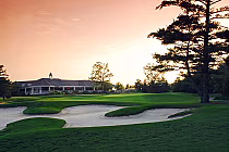 Serene sunset over RattleSnake Point Golf Club, Milton, Ontario, featuring lush greens, sand bunkers, and a clubhouse.