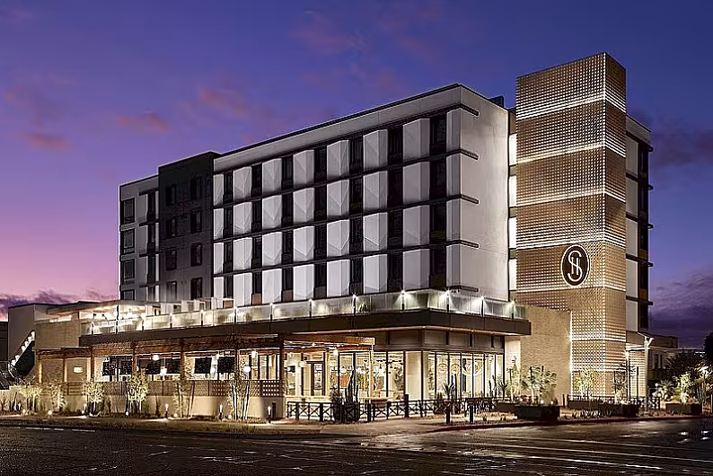 Modern hotel exterior at dusk with illuminated facade and distinct architecture in Scottsdale, Arizona.