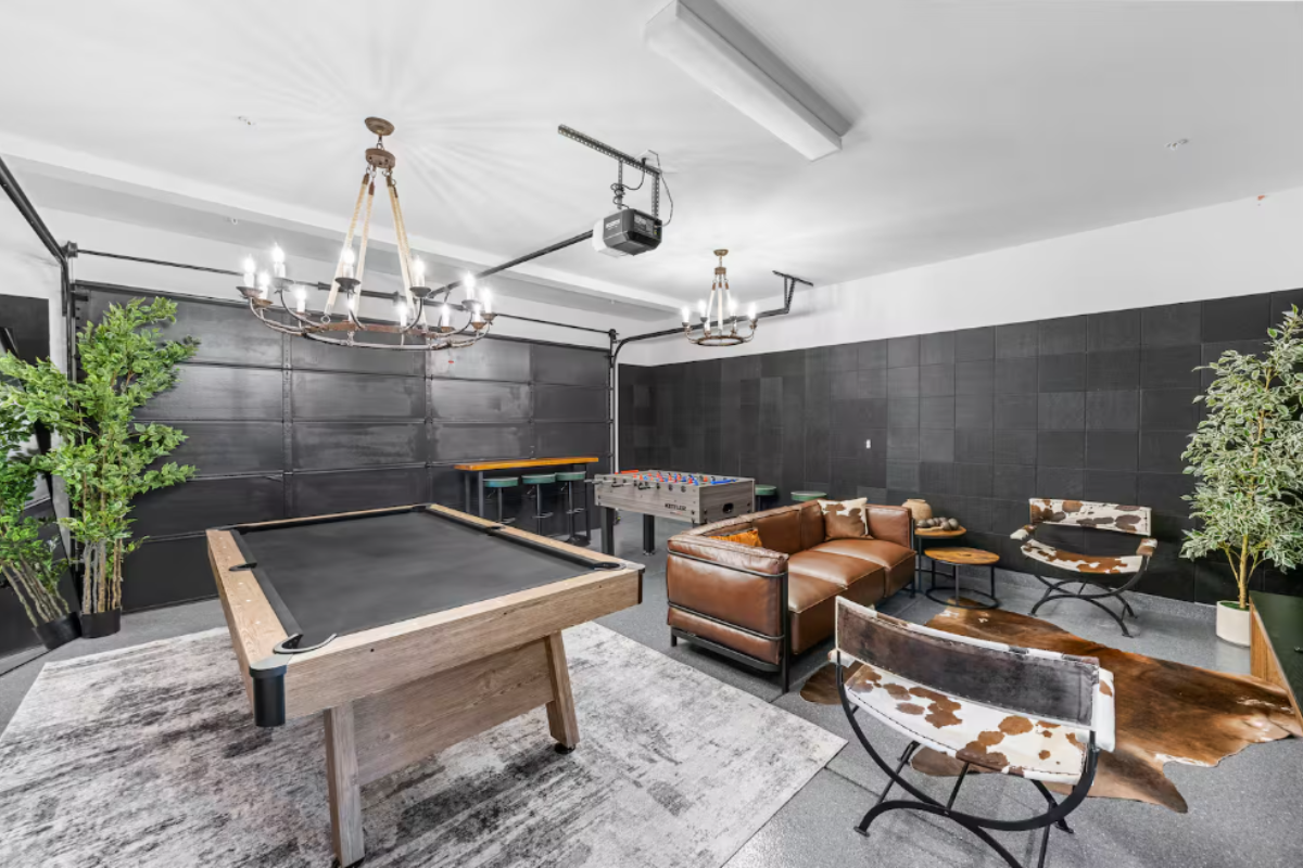 7BR Design Estate w/Heated Zero-Edge Pool & Game Room Luxurious game room in a Coachella estate featuring a pool table, foosball, leather seating, modern decor, and chandeliers.