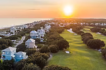 Scenic view of Kiva Dunes Resort Golf Course at sunset, featuring lush fairways, coastal homes, and serene Alabama Gulf Coast.