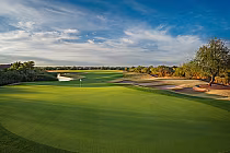 Dove Valley Ranch golf course with lush green fairways and sand bunkers under a clear blue sky, designed by Robert Trent Jones Jr.