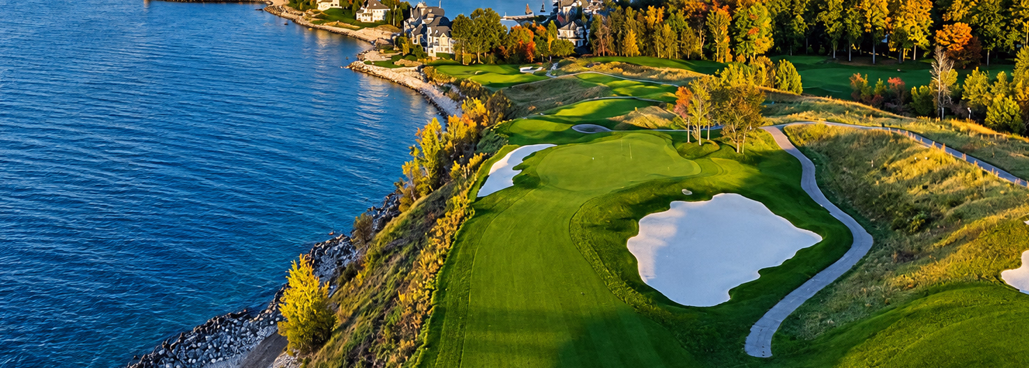 Lakeside Michigan golf course with a green, sand bunkers, and autumn foliage.