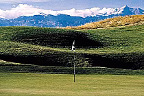 Scenic golf course with lush green fairways, flagstick, and mountain backdrop at Buffalo Run Golf Course, Colorado.