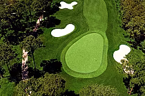 Aerial view of Lion's Paw golf course with lush green fairways, sand bunkers, and surrounding trees at Big Cats Golf.