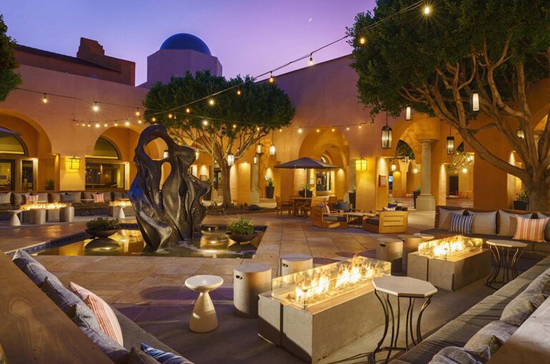 The Westin Rancho Mirage Golf Resort & Spa Elegant outdoor courtyard at Westin Rancho Mirage Golf Resort & Spa with ambient lighting, modern sculptures, and cozy seating areas.