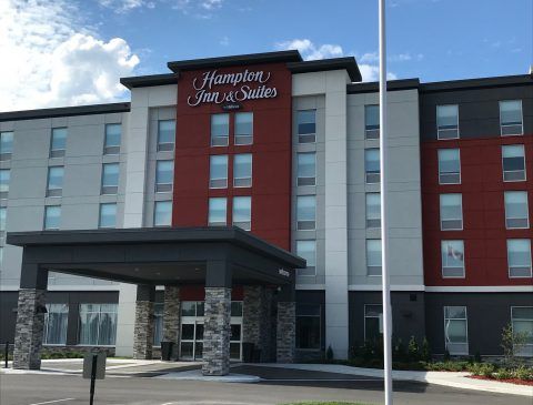Hampton Inn and Suites Belleville Modern Hampton Inn & Suites hotel in Belleville with a red and gray exterior, stone accents, and a welcoming entrance.