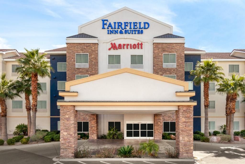 Fairfied Inn & Suites Las Vegas Exterior view of Fairfield Inn & Suites Las Vegas with palm trees, brick accents, and clear blue sky.
