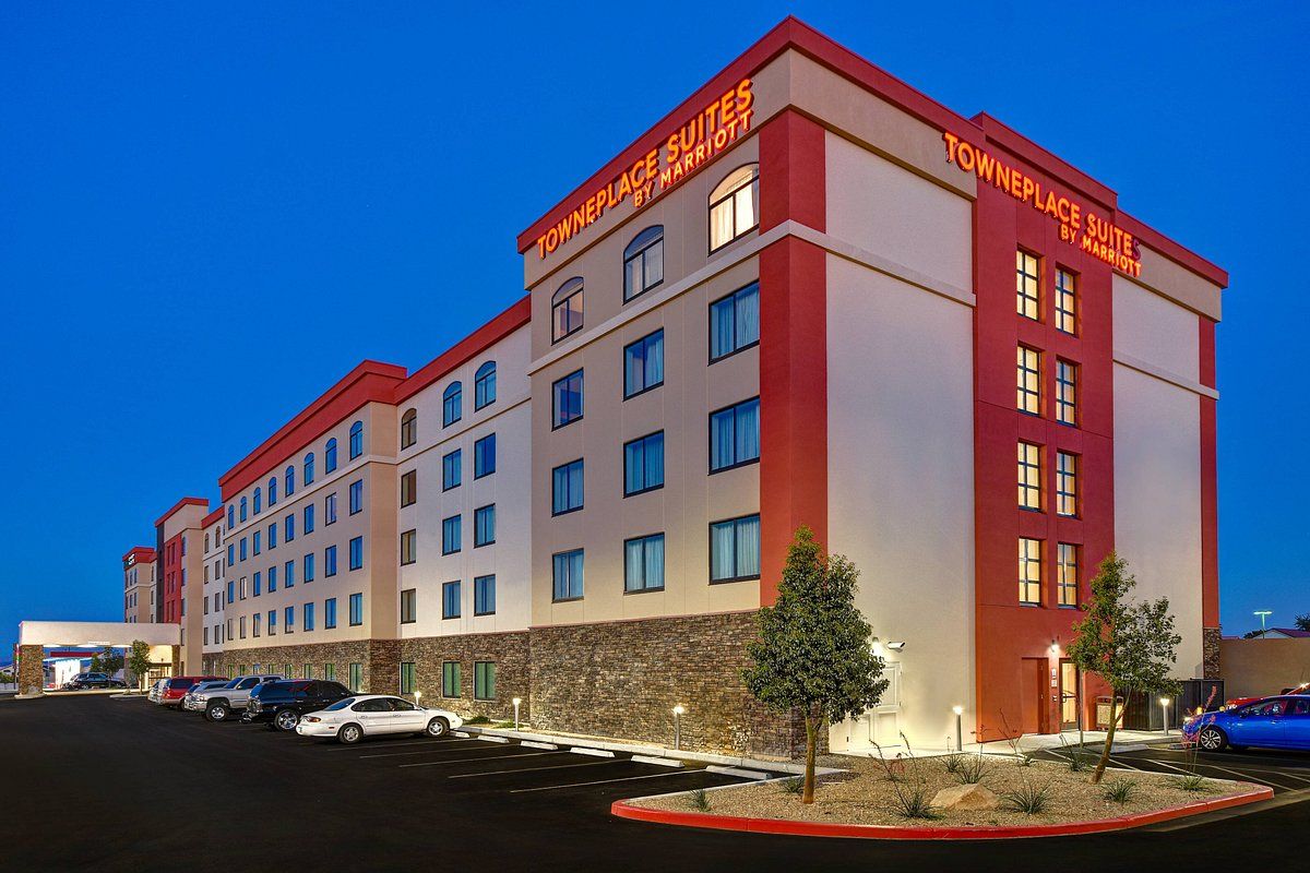 Townplace Suites Las Vegas South Exterior view of Townplace Suites Las Vegas South hotel at dusk, with illuminated signage and a parking lot in the foreground.
