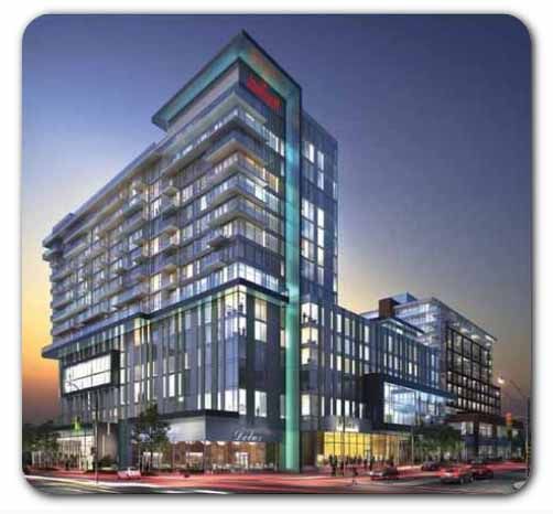 Toronto Marriott Markham Modern multi-story hotel building with glass windows illuminated at dusk, located in downtown Markham, Toronto.