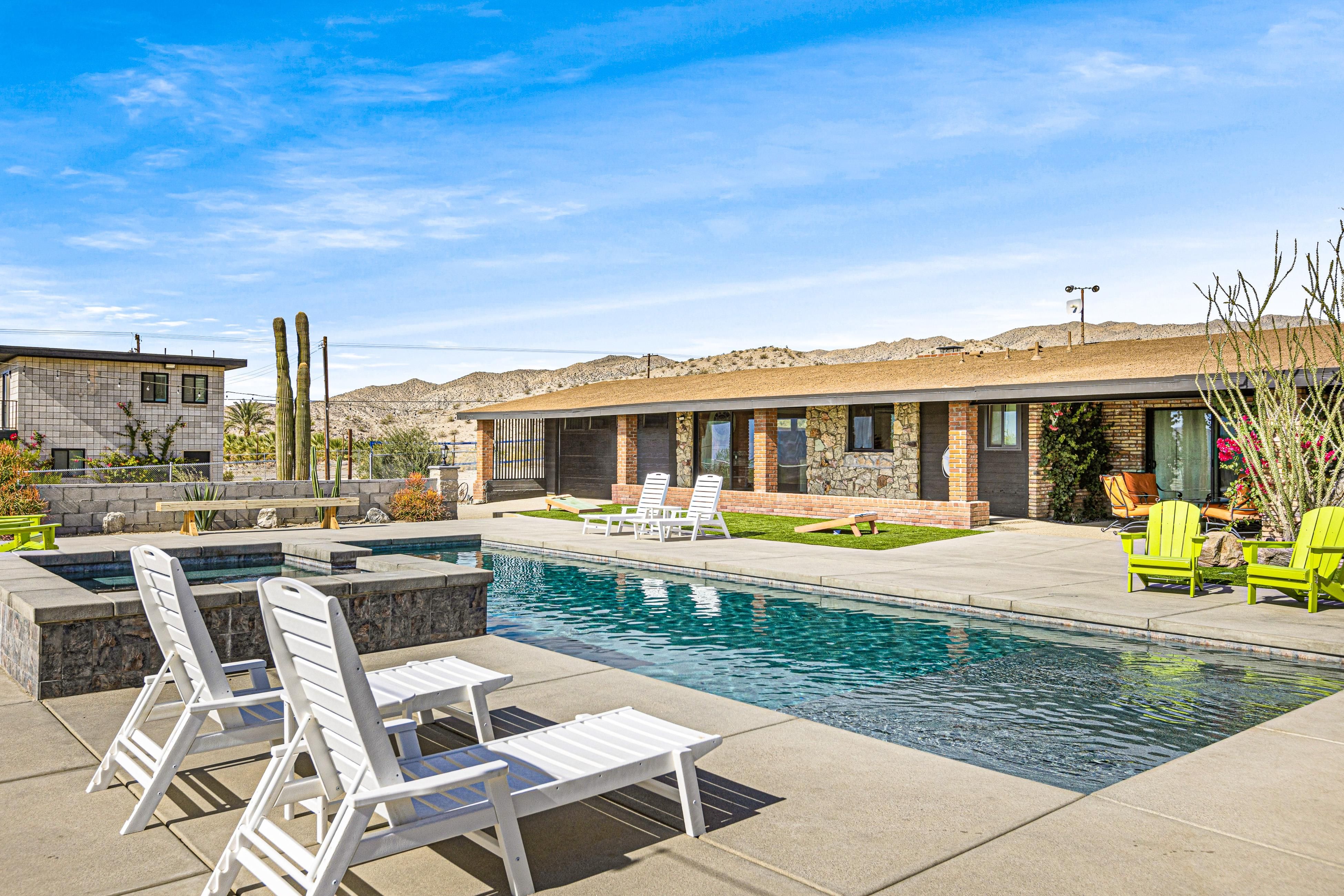 Saguaro Gardens Desert Retreat Luxurious 5-acre desert retreat with a private pool, spa, and succulent garden, set against desert mountains under a blue sky.