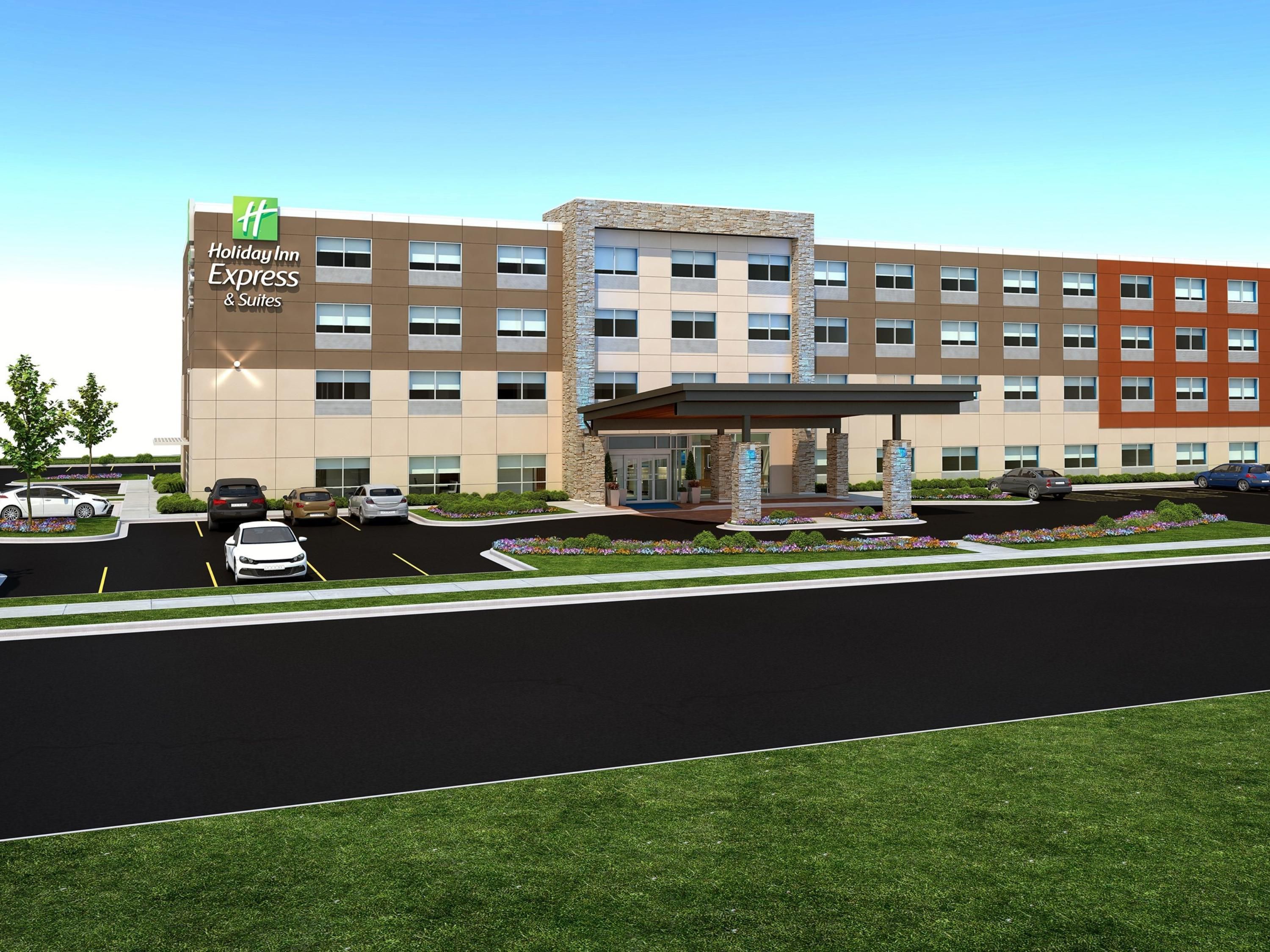 Holiday Inn Express and Suites Aurora Modern Holiday Inn Express & Suites hotel with a landscaped entrance, parking lot, and clear blue sky, ideal for a golf vacation stay.