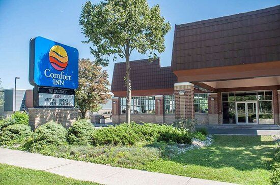 Comfort Inn Lundys Lane Comfort Inn Lundys Lane hotel with a blue sign, brick building, trees, and well-maintained landscaping in Niagara Falls.