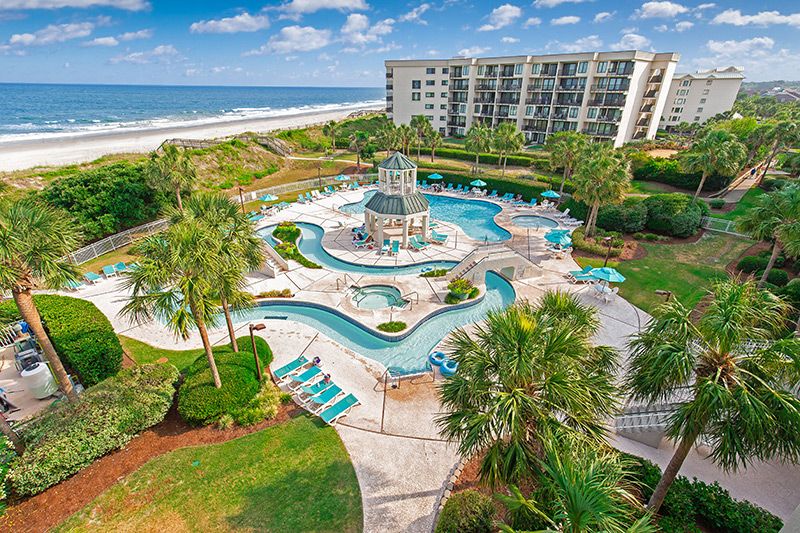 Litchfield Beach & Golf Resort Aerial view of Litchfield Beach & Golf Resort with a pool area, palm trees, beach, and ocean in South Carolina.