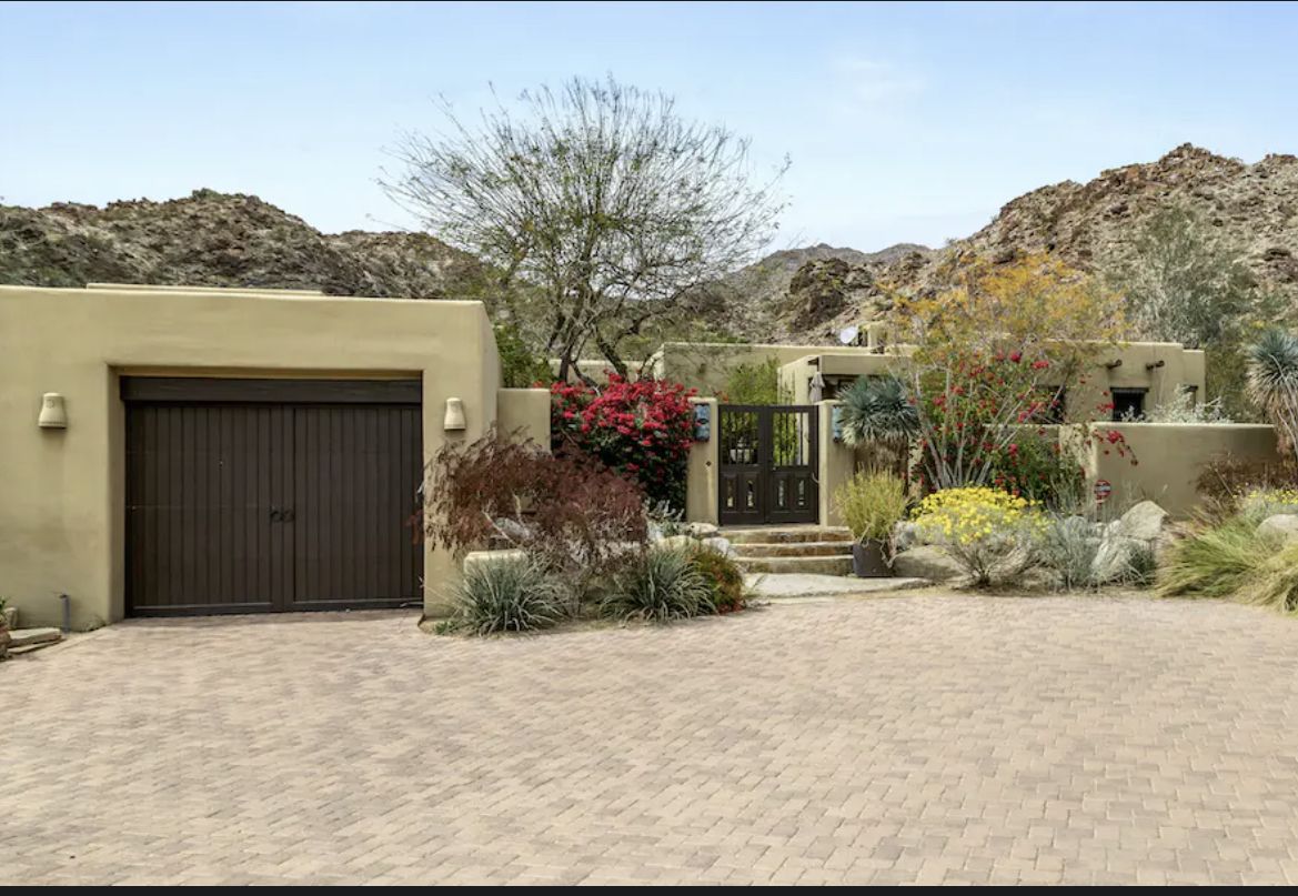 Canyon Oasis - Palm Desert, CA Exterior view of Canyon Oasis in Palm Desert, CA, featuring a desert landscape, a gated entrance, and mountain backdrop.