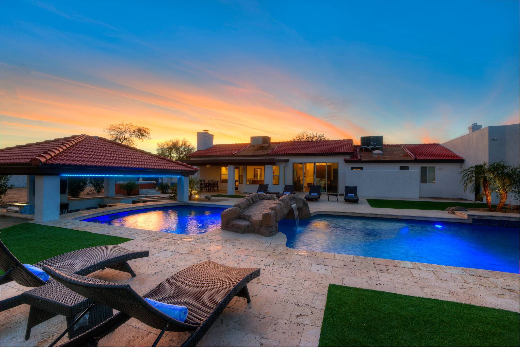 Scottsdale vacation home with a private pool, outdoor lounge, and sunset sky, featuring a 7-bedroom villa with golf amenities.