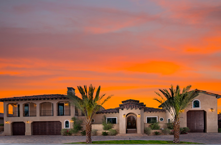 THE BORDEAUX Luxury villa with Mediterranean architecture, palm trees, and a vibrant sunset sky, perfect for a golf vacation rental in Bordeaux.