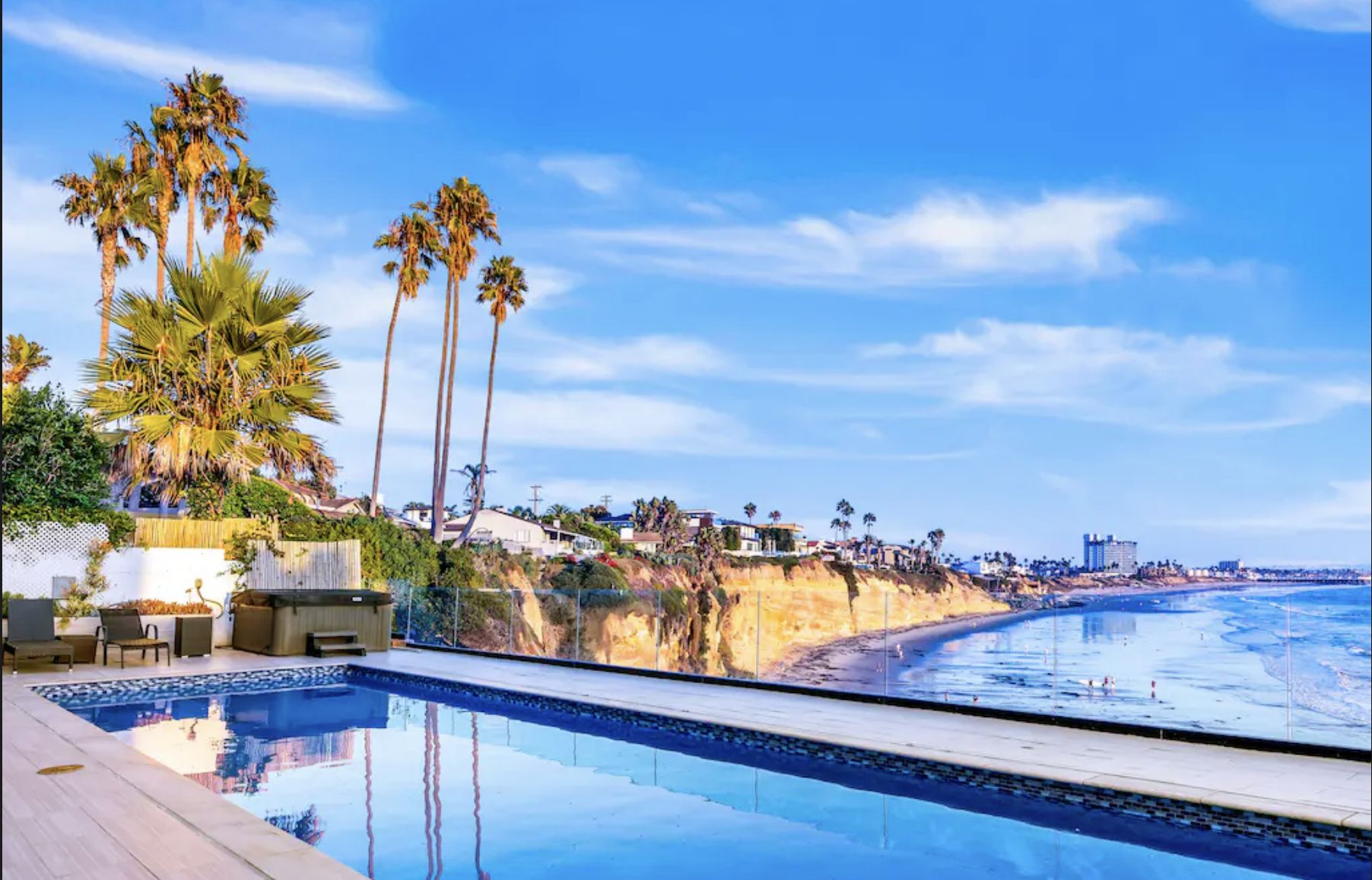 Luxurious oceanfront villa in La Jolla, CA with private pool, overlooking cliffs and the Pacific Ocean, perfect for families and groups.