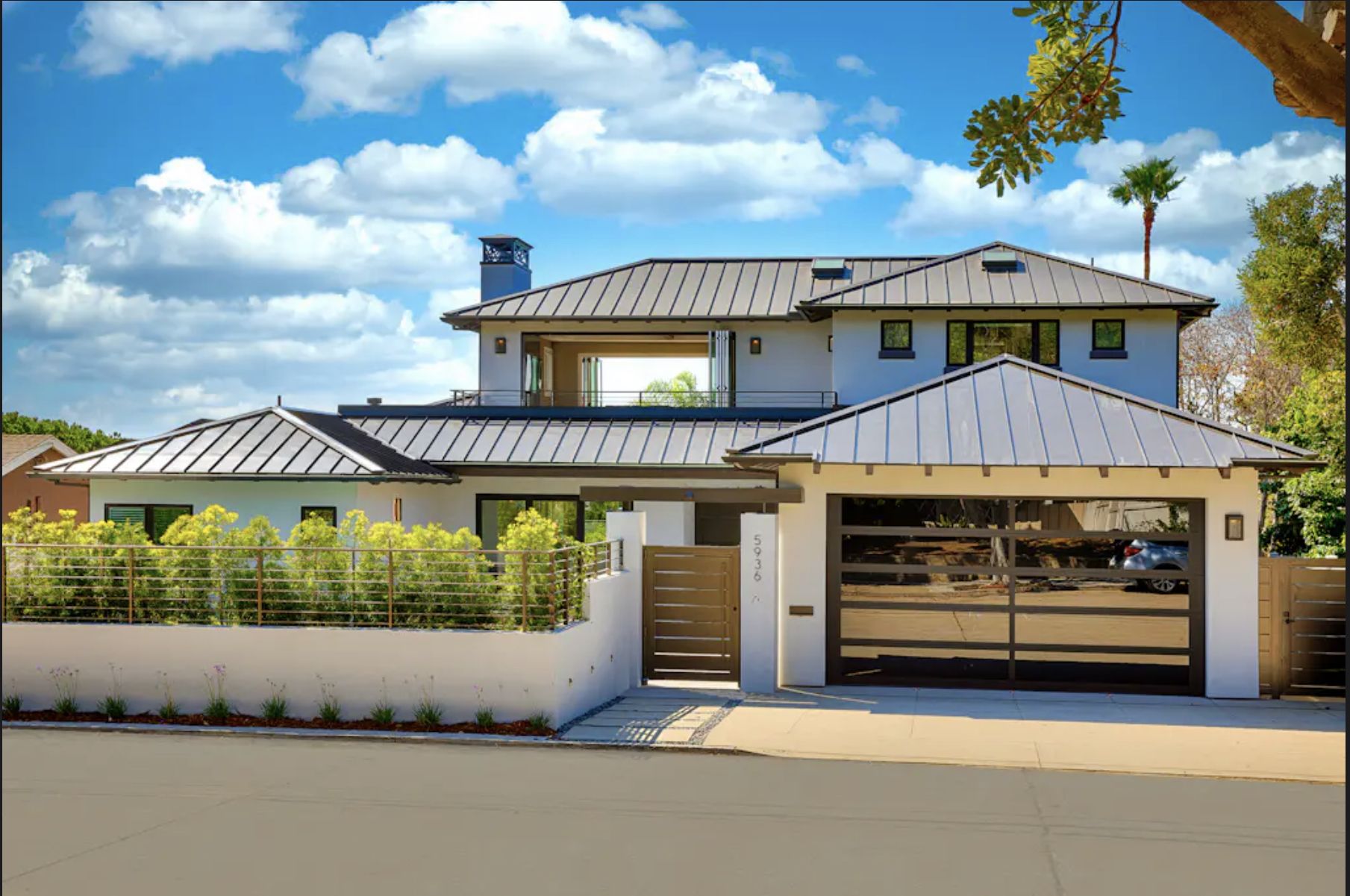 Luxury Bird Rock home in La Jolla, CA with modern design, pool, hot tub, and close to golf courses, under a blue sky.
