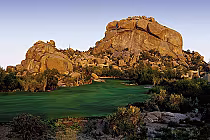 Boulders Golf Club features a desert golf course with dramatic boulder formations and lush green fairways surrounded by desert vegetation.