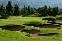 Beautiful golf course at Raven Golf Club Phoenix with lush green fairways, sand bunkers, and scenic mountain backdrop.