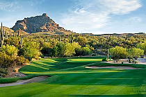 Beautiful desert golf course with lush green fairways, cacti, and a mountain backdrop at We-Ko-Pa, Arizona.