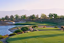 Scenic view of La Quinta Greg Norman Course at PGA West with lush green fairways, water hazards, and desert landscape in Palm Springs.