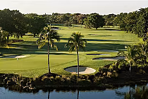 Golf course at Trump National Doral with water hazards, white sand bunkers, lush Bermuda grass, and palm trees, showcasing a demanding layout.