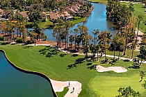 Aerial view of Eagle Creek Golf Course featuring lush green fairways, water hazards, sand bunkers, and surrounding trees.