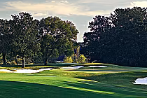 Luxurious golf course at Highland Oaks in Southeast Alabama with lush green fairways, sand traps, and mature trees.