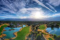 Aerial view of Mission Hills North Gary Player Course in Rancho Mirage, featuring lush green fairways, water hazards, and scenic mountain backdrop.