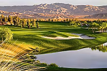 Beautiful golf course with lush green fairways, sand bunkers, trees, water hazards, and mountain backdrop at Arnold Palmer’s Classic Club.