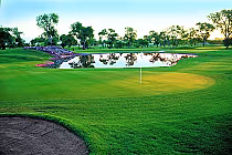 Beautiful golf course at Las Vegas Golf Club with a water hazard, green fairways, and trees, perfect for golf, events, or vacations.