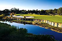 Scenic view of Innisbrook Golf Club's South Course with lush green fairways, a water hazard, and a clear blue sky.