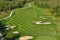 Aerial view of Cranberry Golf Club in Ontario, showcasing lush green fairways, sand bunkers, and surrounding trees in a scenic setting.