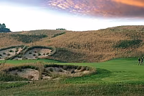 Scenic view of Bond Head Golf Club with lush green fairways, rolling hills, and colorful sunset sky.