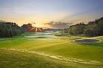 Sunset over a lush green golf course at Royal Ashburn Golf Club in Whitby, Ontario, with trees and a small pond visible.