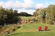 Scenic view of Smugglers Glen Golf Course with lush green fairways, trees, and a partly cloudy sky, showcasing a championship 18-hole course.