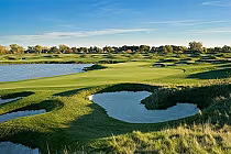 Scenic view of a golf course at Ambassador Golf Club in Windsor, Ontario, featuring lush green fairways, water hazards, and trees.