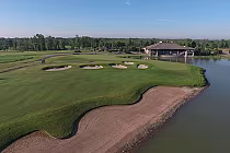 Aerial view of Battlefield Golf Course with lush green fairways, sand bunkers, water hazards, and a clubhouse in the background.