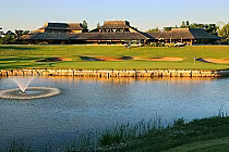 Glen Abbey Golf Club in Oakville, Ontario, featuring a clubhouse, a golf course with sand traps, and a water fountain in a scenic setting.